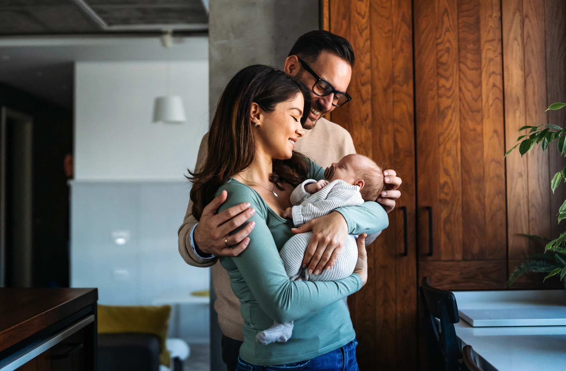 parents holding their adopted newborn
