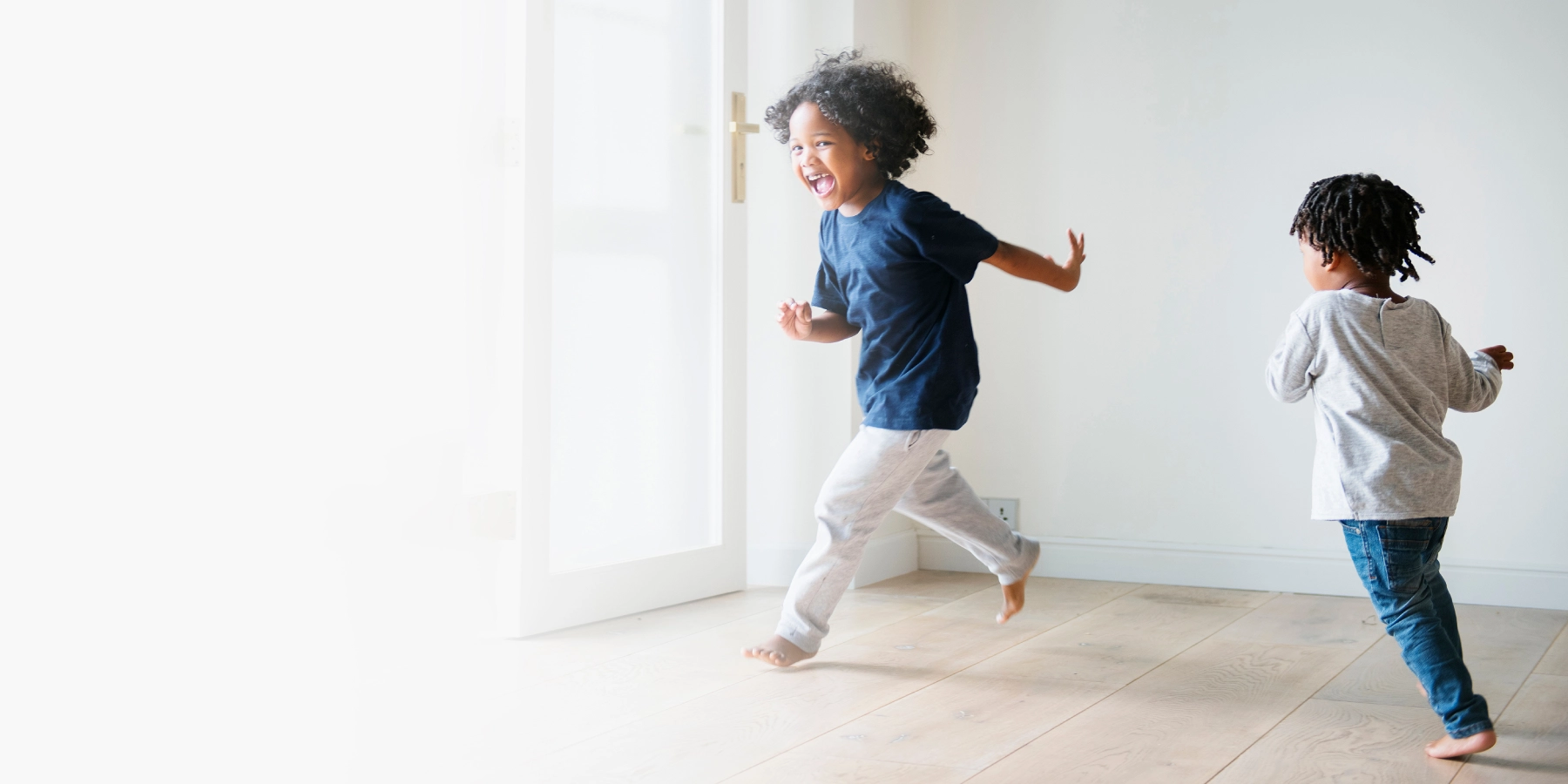 2 kids running around smiling