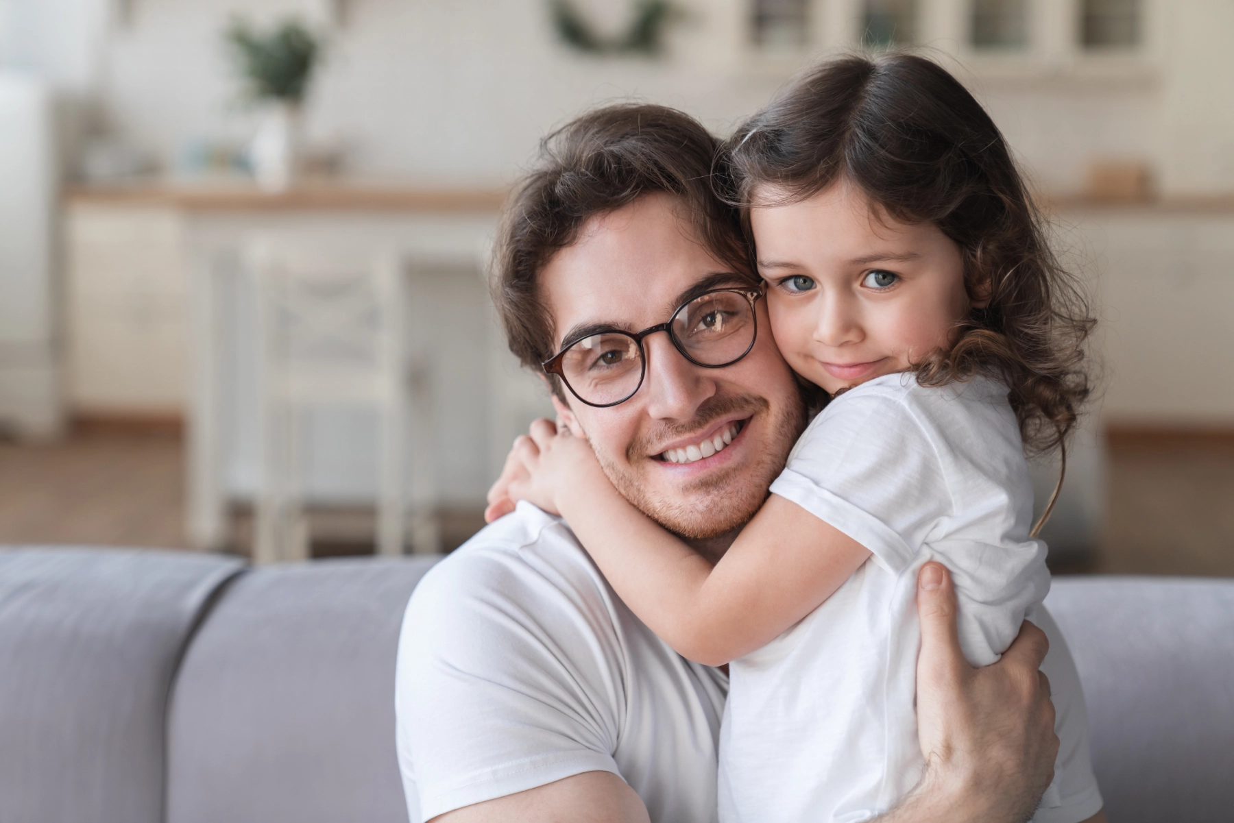 father and daughter hugging and smiling