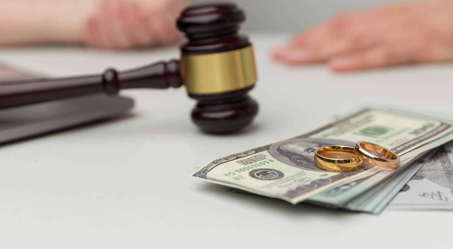 money with two rings on it with a gavel in the background